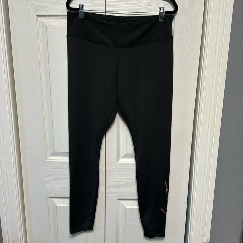 Nike women’s black compression pants size XL, no drawstring, gold Nike swoosh